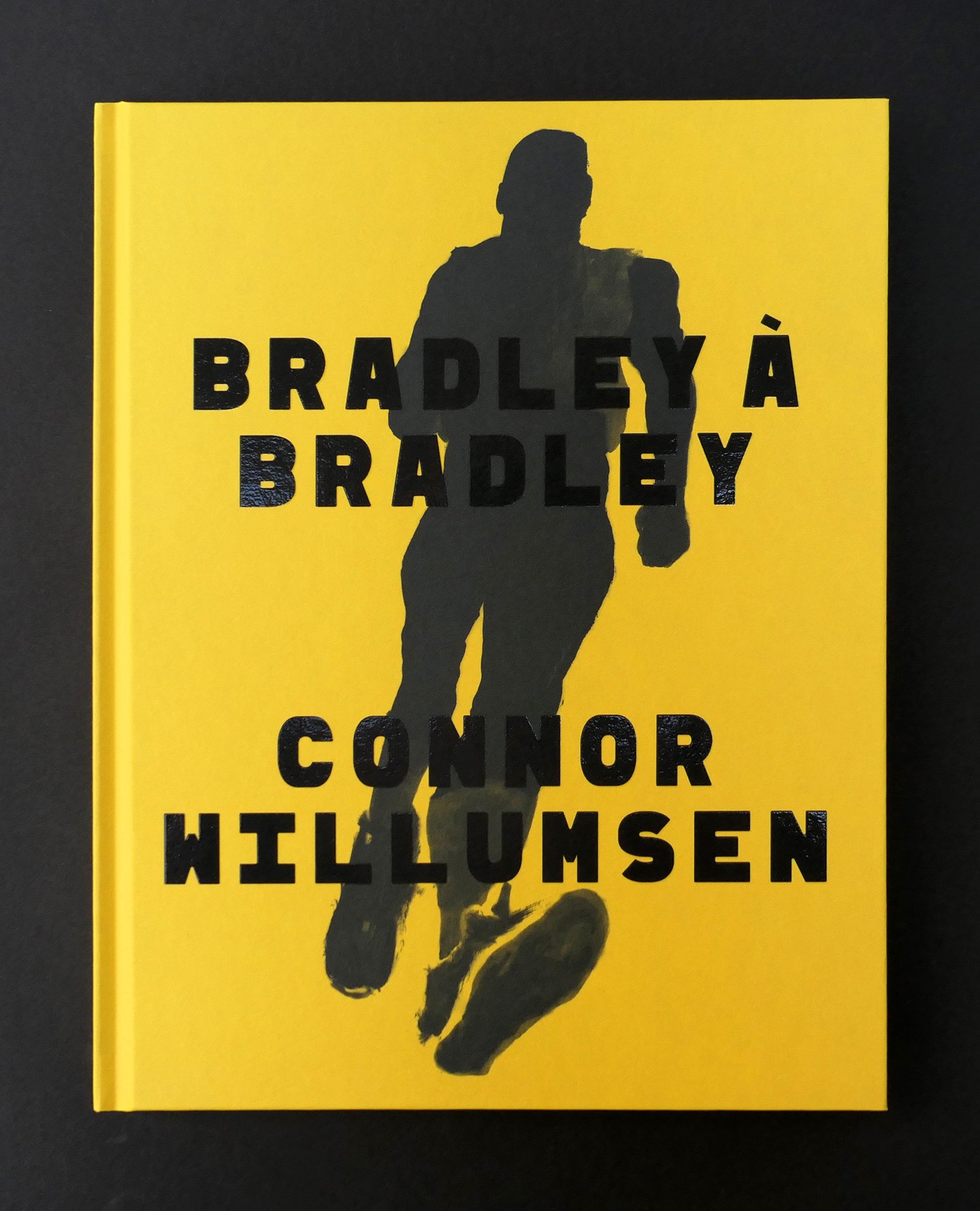 Book cover with a bold black silhouette of a running figure against a bright mustard-yellow background.